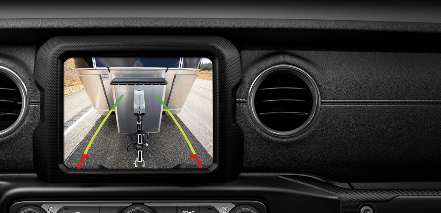 Uconnect system with rear hitch camera showing a trailer being towed