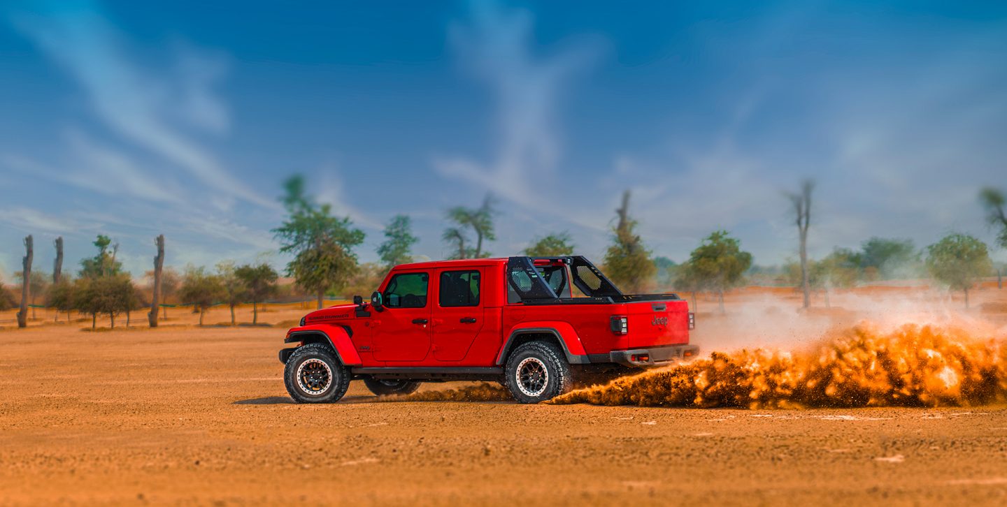 The 2022 Jeep Gladiator Rubicon towing an enclosed trailer on a snowy mountain road.