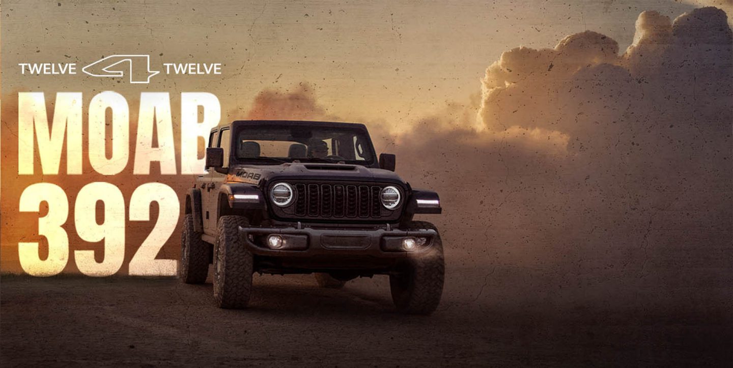 A dark gray 2026 Jeep Wrangler Moab 392 with clouds of smoke billowing in the background. 12 for 12 Moab 392.